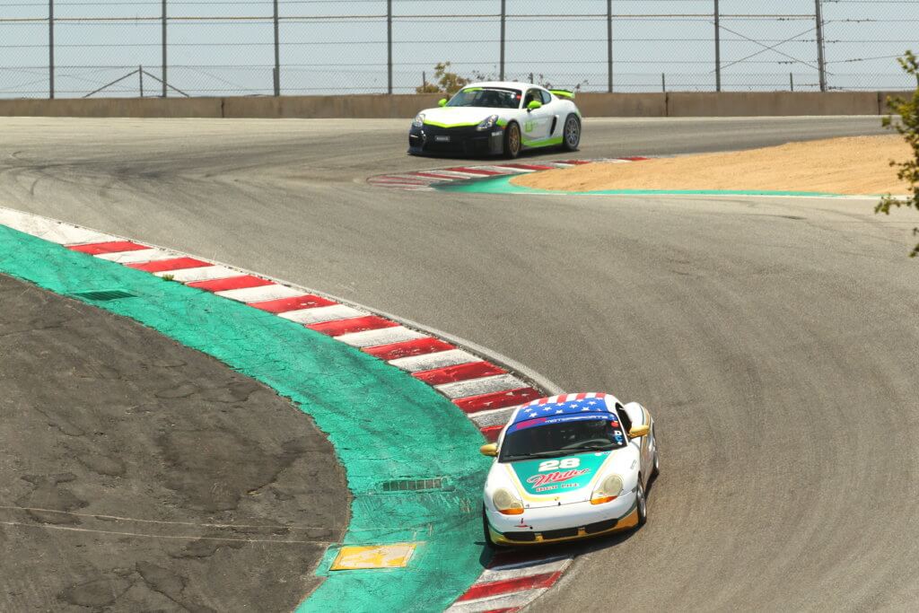 2 SP Motorsports' Arrive and Drive cars, the Spec Boxster, and the GT4 Clubsport, coming down the Corkscrew at Laguna Seca