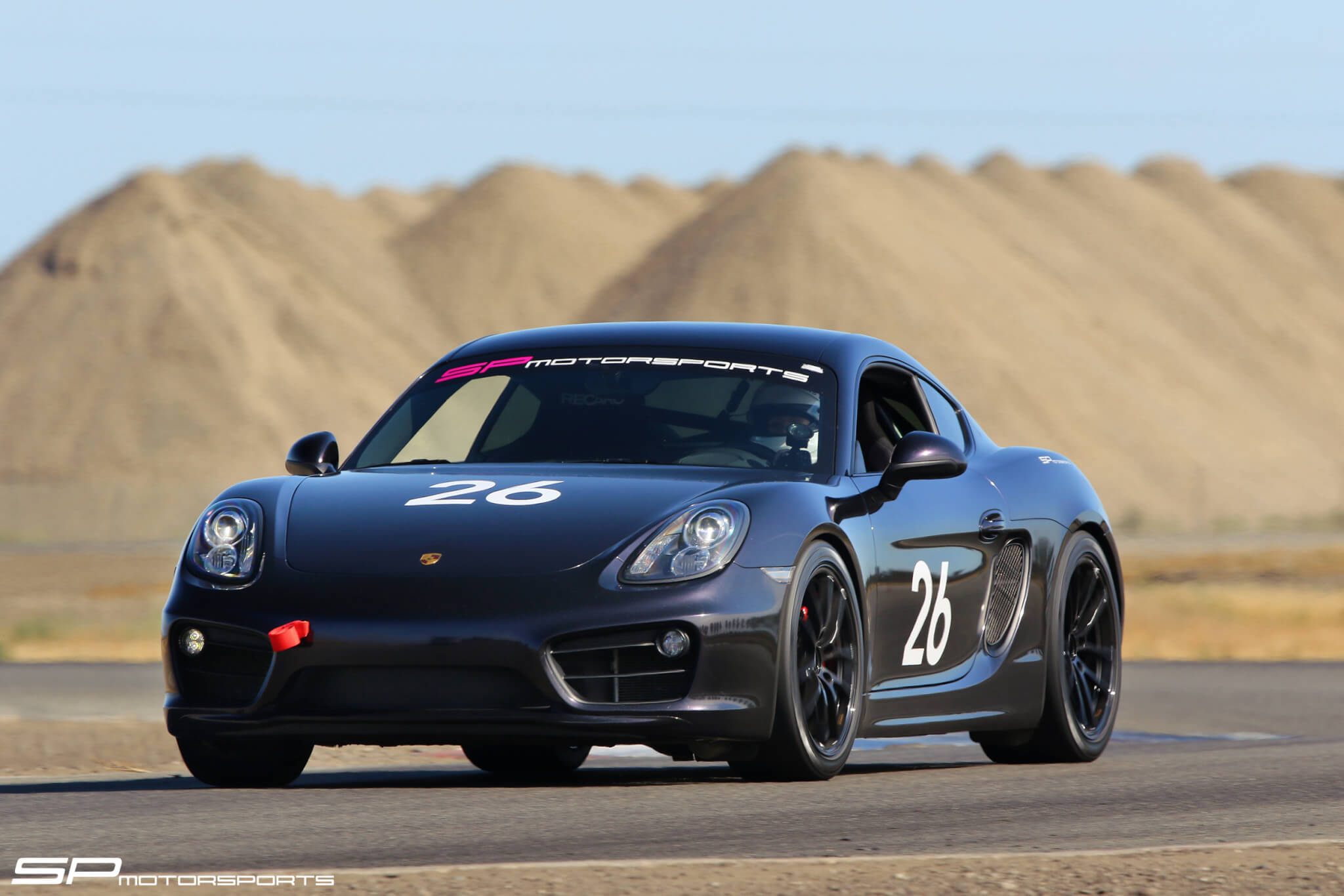 Close up of SP Motorsports Cayman S driving down Buttonwillow Raceway