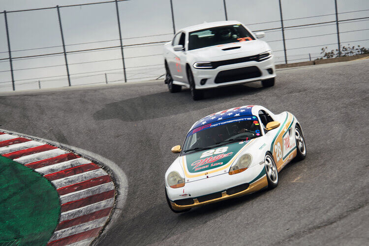 Spec Boxster gets the lead on a Charger at Laguna Seca