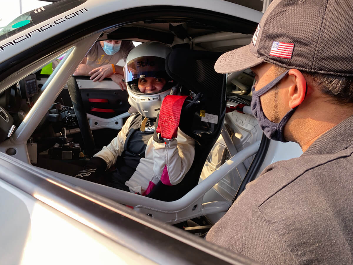 Tech crew helping client prepare for on track experience